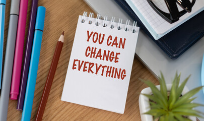 A notebook with the words You Can Change Everything written on it.