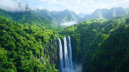 Fototapeta premium Breathtaking waterfall cascading down lush green mountains, surrounded by vibrant foliage and misty clouds, creating serene natural landscape