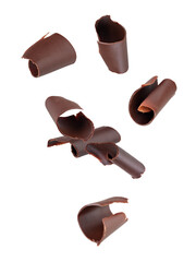 Chocolate curls fall into space. Isolated on white.
