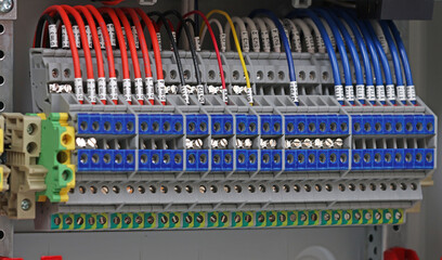 Electrical screw terminals for connecting wires in an electrical switchboard. Soft focus. Close-up.