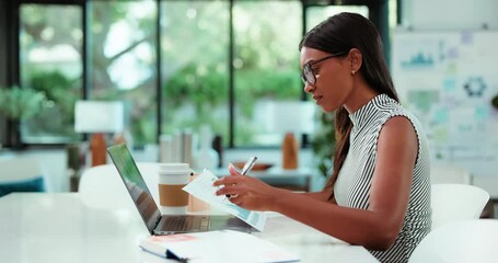 Notes, laptop or Indian woman in office with paper, budget or data analysis for forecast report. Finance, tech or analyst in agency with writing, risk assessment or business plan for company growth - Powered by Adobe