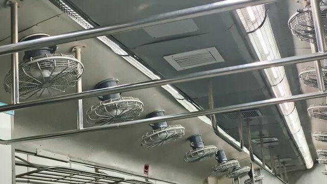 Hubli, Karnataka, India &ndash; November 21, 2025: Ceiling fans, metal rails, and lighting inside an Indian train coach. Editorial view of everyday public transportation design.