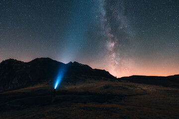 Naklejka premium Milky way shining over mountain and pond in Dolomites, Italy