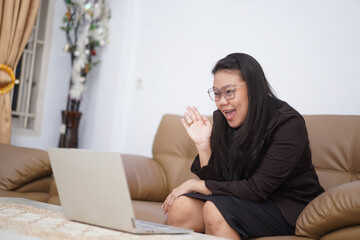 Cheerful Woman Waving Hello on Video Call