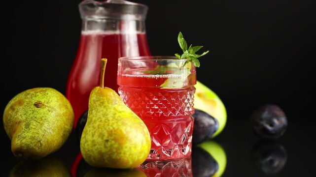 Summer homemade compote of fresh fruits on black background