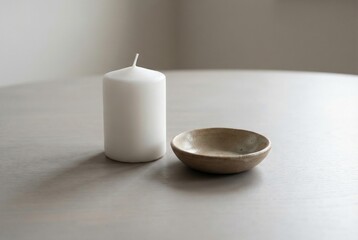 Neutral winter home decor with ceramic candle and dish