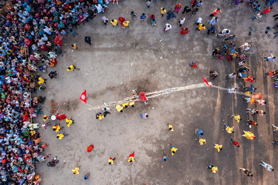 Aerial view of a bustling crowd gathered around a central point marked by flags and structures, Dhaka, Dhaka Division, Bangladesh.