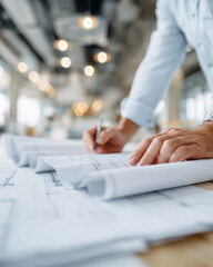 A man is writing on a piece of paper with a pen