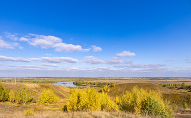 Beautiful blue sky with a few clouds and a river in the background