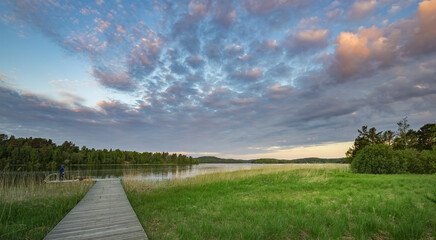 Bridge over a lake with a cloudy sky in the background