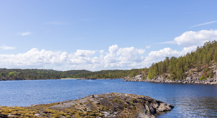 Beautiful lake with a rocky shoreline and a clear blue sky