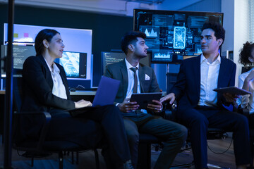 Diverse high performing team of data analysts and IT professionals collaborating in a control room. innovation, global business strategy, cybersecurity, and financial technology growth
