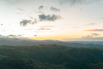 Soft Sunrise Haze and Warm Golden Glow over the Rolling Tropical Hills of Costa Rica