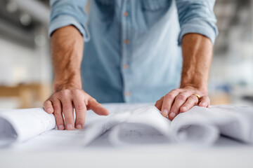 A man is holding a piece of paper with a design on it