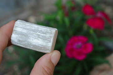 hand holding a selenite