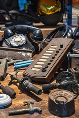 Nostalgic assortment of old household items including a Bakelite phone and switchboard.