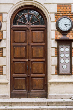 Historic wooden door and meteorological instruments (pluviometer) on the facade of the Torre del Rellotge in Can Solei i Ca l'Arnus park. Badalona, Spain