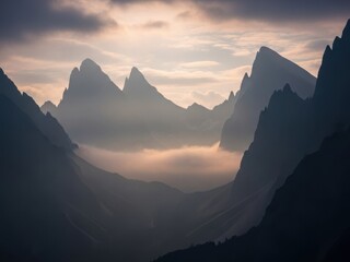 Dramatic mountain range shrouded in mist at sunrise for adventure travel