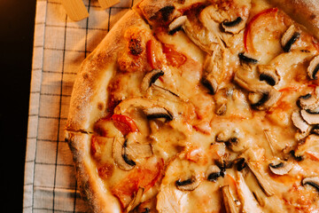Delicious pizza with cheese, chicken, and mushrooms ready to be enjoyed for lunch or dinner