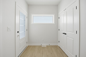 Hallway with a door leading to a closet