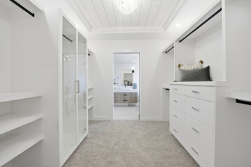 Large walk in closet with a mirror and a bathroom