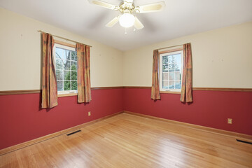 Room with a red wall and white trim