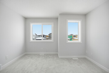 Room with two windows and a white wall