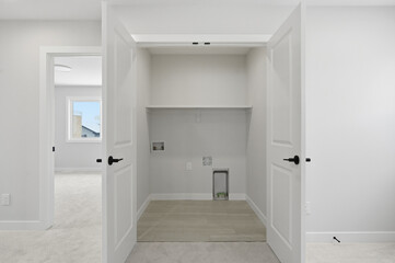 White bathroom with a washer and dryer