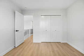 Obraz premium White bedroom with a white closet and a white door