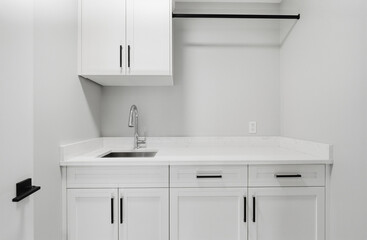 White kitchen with a sink and a rack