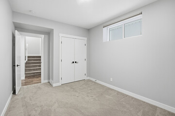 White room with a window and a closet