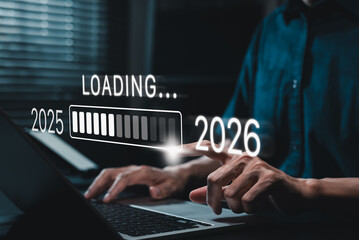 Progress and transition from 2025 to 2026 concept. A person pointing to loading bar transitioning...