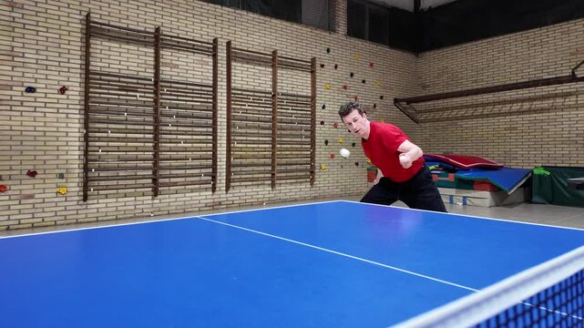 professional player does a forehand top-spin during training on a blue table, table tennis