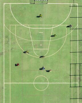 Aerial view of players scattered across the court, their colorful kits a stark contrast against the green surface, Lisbon, Lisbon, Portugal.