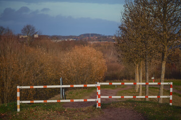 Silent rural road, Old weathered barrier obstructs peaceful lane