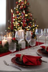Festive table setting with Christmas decor indoors, closeup