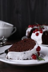 Tasty Christmas cake with cranberries and rosemary served on table, closeup