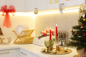 Christmas decor and glasses on countertop in kitchen. Interior design