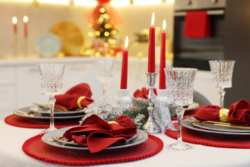 Festive table setting with Christmas decor in kitchen, closeup. Interior design