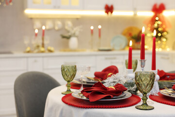 Festive table setting with Christmas decor in kitchen, closeup. Interior design