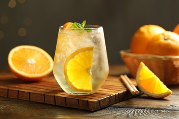 Refreshing spritzer cocktail with mint on wooden table, closeup