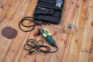 Working tools for repairs on a wooden floor.