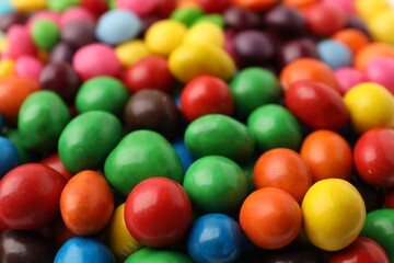 Many delicious colorful candies as background, closeup
