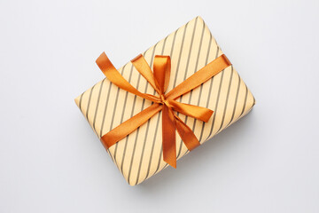 Beautiful wrapped gift on light background, top view