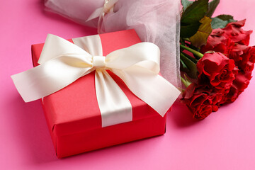 Saint Valentine's day. Beautiful gift and roses on pink background, closeup