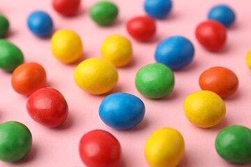 Delicious colorful candies on pink background, closeup