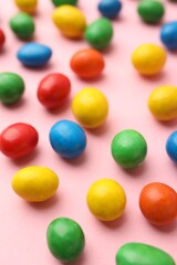 Delicious colorful candies on pink background, closeup