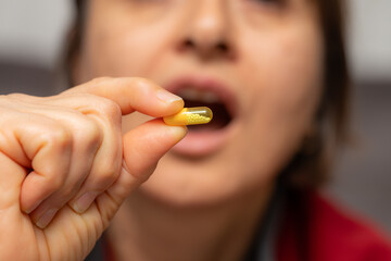 A woman who takes medication when she is sick. Excessive medication use negatively affects health.