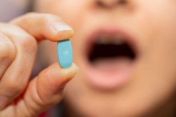 A woman who takes medication when she is sick. Excessive medication use negatively affects health.