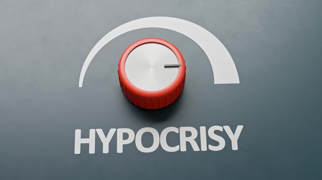Hypocrisy concept. A rotary knob with the label "Hypocrisy" turned to full volume. 100% hypocrisy. Maximum hypocrisy. Camera moving up